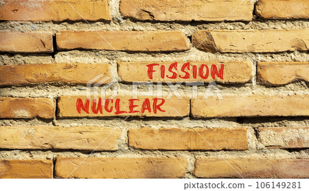 Nuclear fission symbol. Concept words Nuclear fission on beautiful brick wall. Beautiful red brown brick wall background. Business science nuclear fission concept. Copy space. 106149281