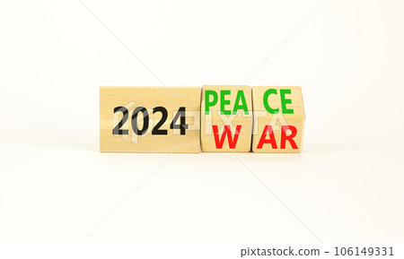 2024 war or peace symbol. Businessman turns a wooden cube and changes words 2024 War to 2024 Peace. Beautiful white table white background, copy space. Business 2024 war or peace concept. 2024 war or peace symbol. Businessman turns a wooden cube and changes words 2024 War to 2024 Peace. Beautiful white table white background, copy space. Business 2024 war or peace concept. 106149331
