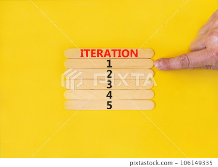 Time to iteration 1 symbol. Concept word Iteration 1 2 3 4 5 on wooden sticks. Businessman hand. Beautiful yellow table yellow background. Business planning and time to iteration 1 concept. Copy space Time to iteration 1 symbol. Concept word Iteration 1 2 3 4 5 on wooden sticks. Businessman hand. Beautiful yellow table yellow background. Business planning and time to iteration 1 concept. Copy space 106149335