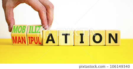 Mobilization or manipulation symbol. Concept words Mobilization Manipulation on wooden cubes. Beautiful white background. Psychologist hand. Psychology mobilization manipulation concept. Copy space. 106149340