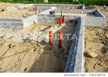 Building the foundation of the house from concrete blocks and installation of pipework system 106149534