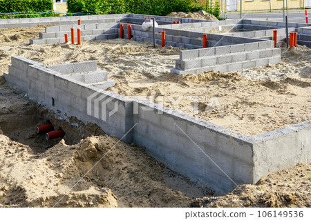 Building the foundation of the house from concrete blocks and installation of pipework system 106149536