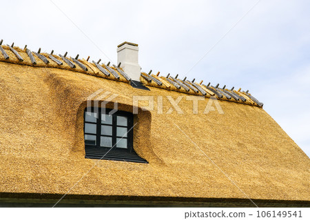New thatch roof over house with dormer window in Denmark, thatched roof, white chimney 106149541