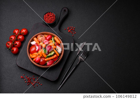 Delicious fresh juicy salad with radishes, tomatoes, carrots, cucumber, spices and herbs Delicious fresh juicy salad with radishes, tomatoes, carrots, cucumber, spices and herbs 106149812