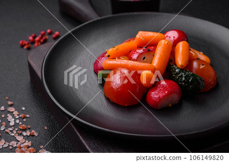 Delicious fresh juicy salad with radishes, tomatoes, carrots, cucumber, spices and herbs 106149820