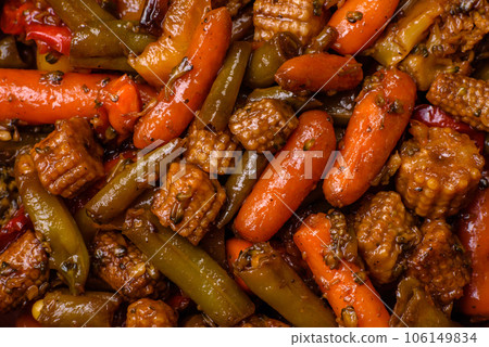 Mix of vegetables corn, carrots, peppers, broccoli, onions in teriyaki sauce on a ceramic plate Mix of vegetables corn, carrots, peppers, broccoli, onions in teriyaki sauce on a ceramic plate 106149834