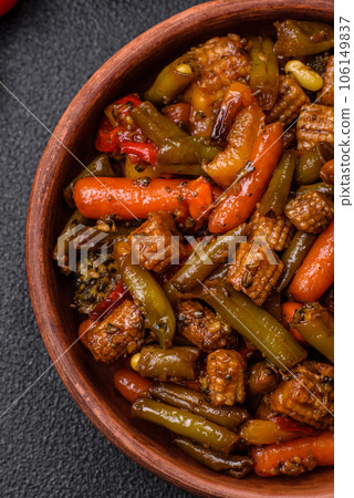 Mix of vegetables corn, carrots, peppers, broccoli, onions in teriyaki sauce on a ceramic plate Mix of vegetables corn, carrots, peppers, broccoli, onions in teriyaki sauce on a ceramic plate 106149837