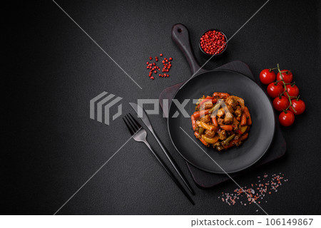 Mix of vegetables corn, carrots, peppers, broccoli, onions in teriyaki sauce on a ceramic plate 106149867