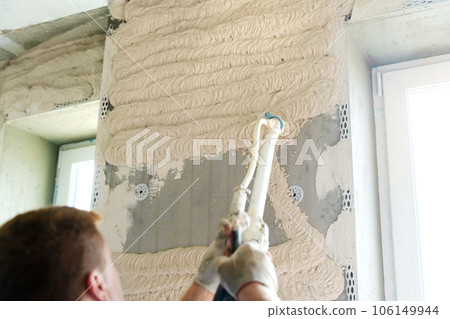 Machine plastering. Applying gypsum plaster by mechanized method in apartment. Machine plastering. Applying gypsum plaster by mechanized method in apartment. 106149944