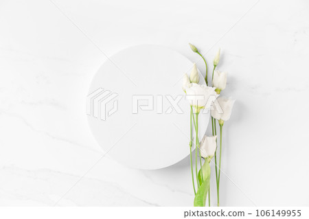 Delicate beauty cosmetics product presentation scene made with white circle podium and eustoma flowers on white table. 106149955