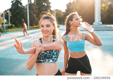 Fit girls fitness training outdoors in the city at sunset. 106149956