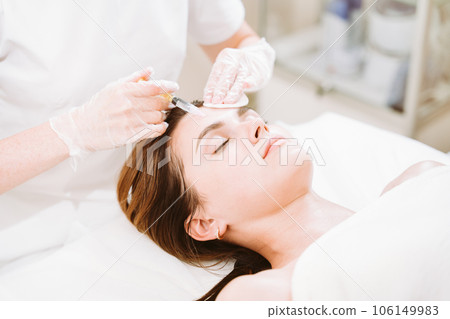 Skin mesotherapy treatment for young woman in modern clinic 106149983