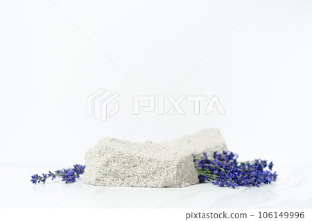 Product presentation scene template made with porous stone podium and lavender flowers on white background. Product presentation scene template made with porous stone podium and lavender flowers on white background. 106149996
