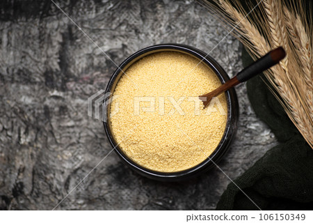 Couscous in a black ceramic bowl 106150349