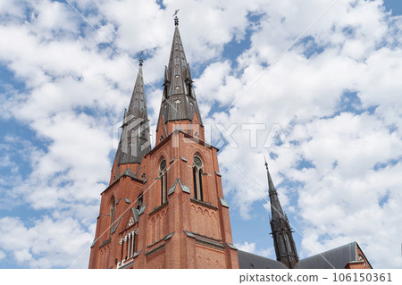 Uppsala Cathedral in Uppsala, Sweden on sky with clouds background 106150361