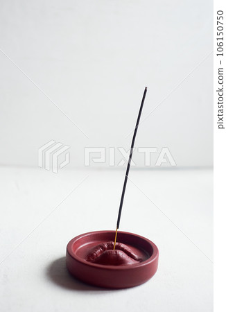 Incense stand red lips. Round shape on a white background. Esotericism, meditation Incense stand red lips. Round shape on a white background. Esotericism, meditation 106150750