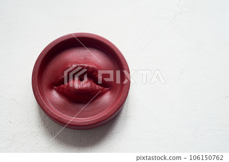 Incense stand red lips. Round shape on a white background. Esotericism, meditation 106150762