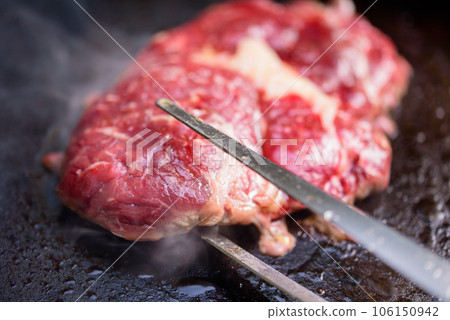 Rib-eye steaks on a gas grill. Chef cooking steak on a grill. 106150942