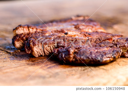 Fresh roast beef meat steak on cutting board. Fresh roast ribeye steak slices. Fresh roast beef meat steak on cutting board. Fresh roast ribeye steak slices. 106150948