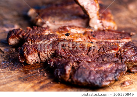 Fresh roast beef meat steak on cutting board. Fresh roast ribeye steak slices. Fresh roast beef meat steak on cutting board. Fresh roast ribeye steak slices. 106150949