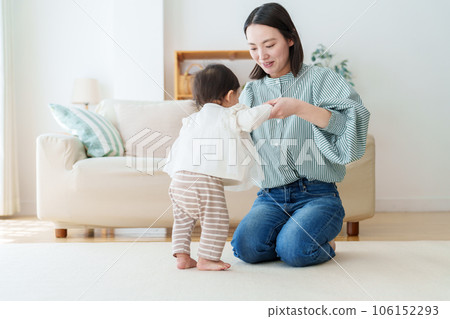mother playing with baby in living room mother playing with baby in living room 106152293