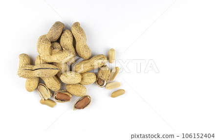 Raw peanuts on a white background, top view. Unshelled peanuts. 106152404
