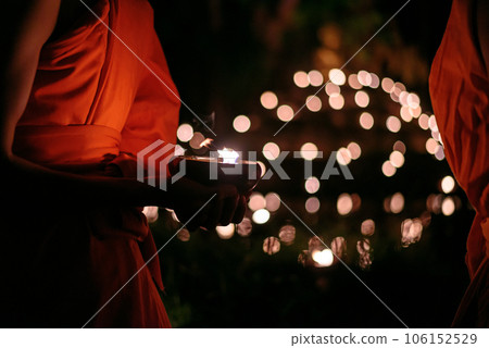 Buddhist monk hands holding candle cup in the dark ,Chiang mai , Thailand Buddhist monk hands holding candle cup in the dark ,Chiang mai , Thailand 106152529