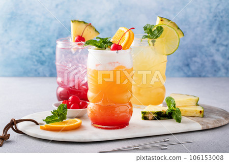 Variety of tiki cocktails in glass cups 106153008