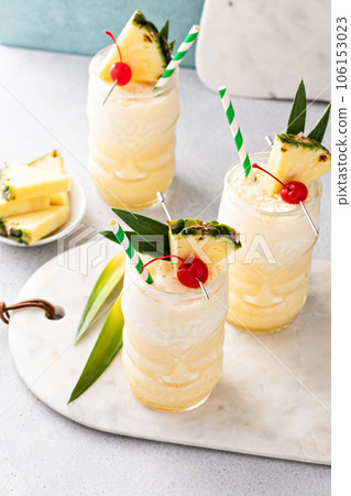 Tropical pina colada cocktail or mocktail in a tiki glass Tropical pina colada cocktail or mocktail in a tiki glass 106153023