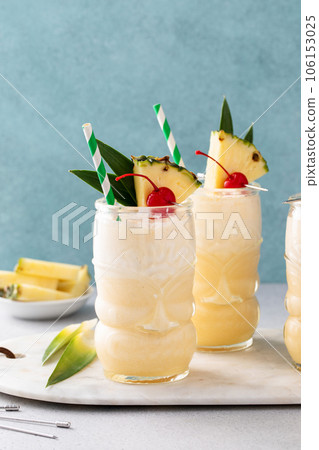 Tropical pina colada cocktail or mocktail in a tiki glass Tropical pina colada cocktail or mocktail in a tiki glass 106153025