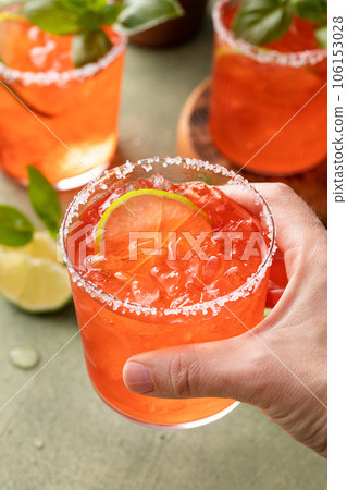 Strawberry basil margarita with lime wedges on the table Strawberry basil margarita with lime wedges on the table 106153028