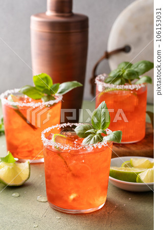 Strawberry basil margarita with lime wedges on the table 106153031