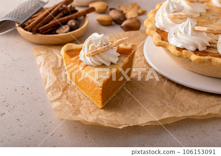 Pumpkin cheesecake swirl pie topped with whipped cream 106153091