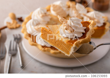 Pumpkin cheesecake swirl pie topped with whipped cream 106153093