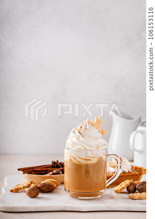 Pumpkin spice latte topped with whipped cream and cinnamon Pumpkin spice latte topped with whipped cream and cinnamon 106153116