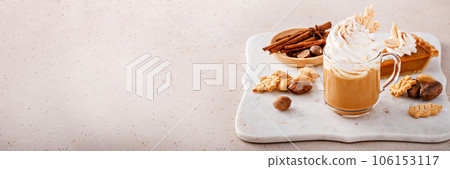 Pumpkin spice latte topped with whipped cream and cinnamon 106153117