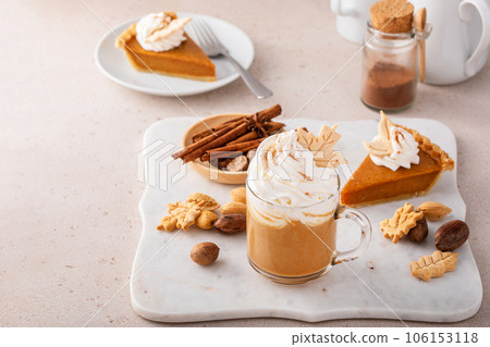 Pumpkin spice latte topped with whipped cream and cinnamon 106153118