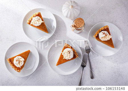 Slices of traditional pumpkin pie in a light and bright setting 106153148