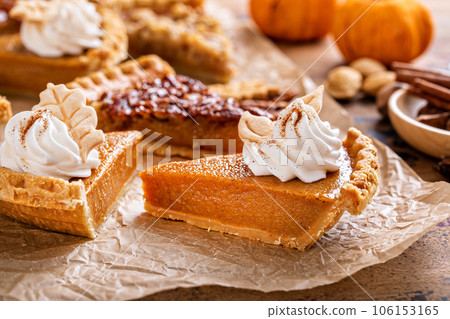 Variety of Thanksgiving pie slices on parchment paper 106153165