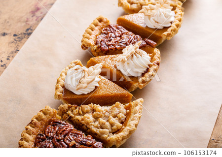 Traditional fall Thanksgiving pie slices, pumpkin and pecan pie 106153174