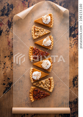 Traditional fall Thanksgiving pie slices, pumpkin and pecan pie Traditional fall Thanksgiving pie slices, pumpkin and pecan pie 106153180