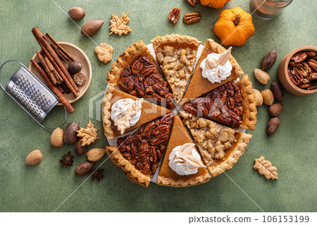Traditional fall Thanksgiving pie slices, pumpkin and pecan pie Traditional fall Thanksgiving pie slices, pumpkin and pecan pie 106153199