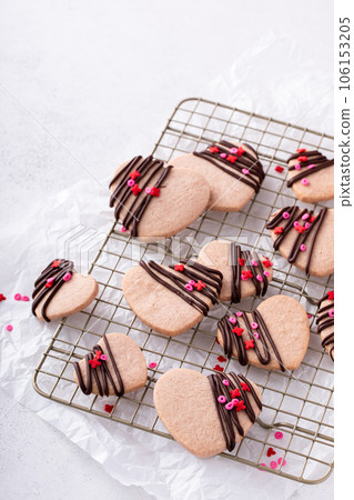 Heart shaped strawberry cut out cookies with dark chocolate Heart shaped strawberry cut out cookies with dark chocolate 106153205