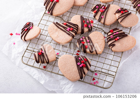 Heart shaped strawberry cut out cookies with dark chocolate Heart shaped strawberry cut out cookies with dark chocolate 106153206