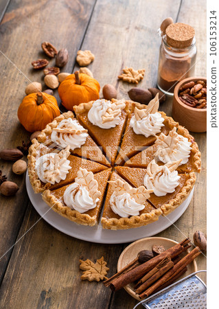 Traditional Thanksgiving pumpkin pie cut into slices Traditional Thanksgiving pumpkin pie cut into slices 106153214