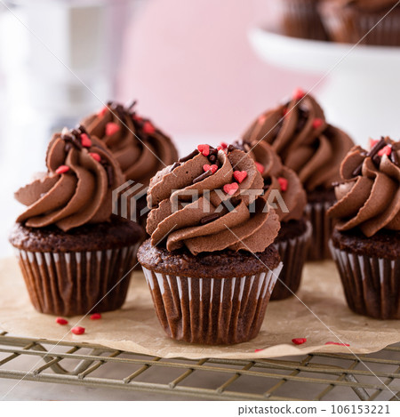 Dark chocolate cupcakes with chocolate ganache frosting Dark chocolate cupcakes with chocolate ganache frosting 106153221
