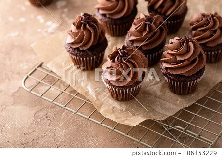 Dark chocolate cupcakes with chocolate ganache frosting 106153229
