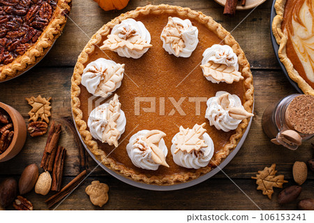 Traditional Thanksgiving pumpkin pie topped with whipped cream 106153241