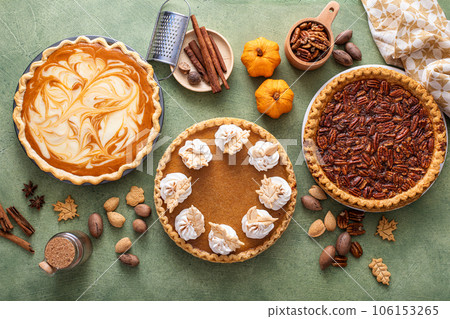 Traditional fall Thanksgiving pies, pumpkin and pecan pie 106153265