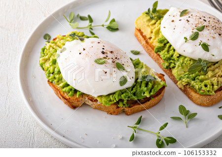 Avocado toast with a poached egg on top Avocado toast with a poached egg on top 106153332